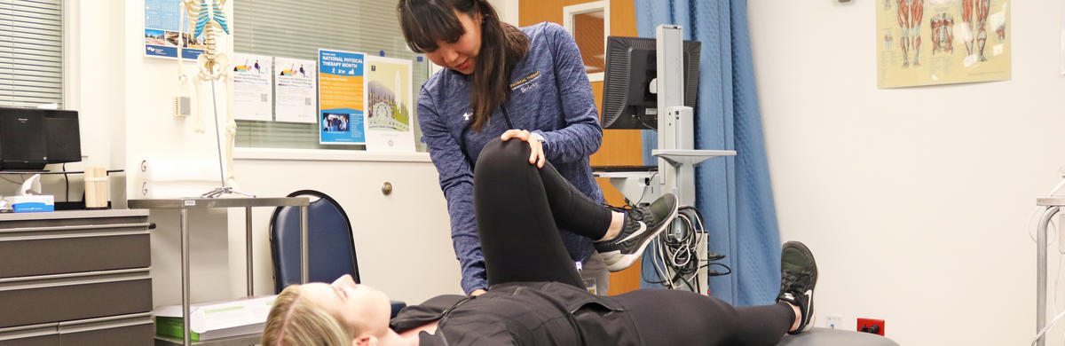 Physical Therapist stretching patient