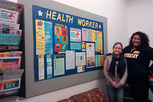 UHS student health workers standing in front of bulletin board