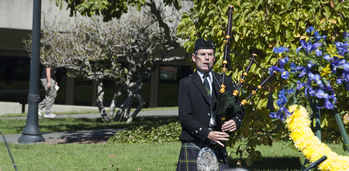 Bagpiper walks to the annual campus memorial