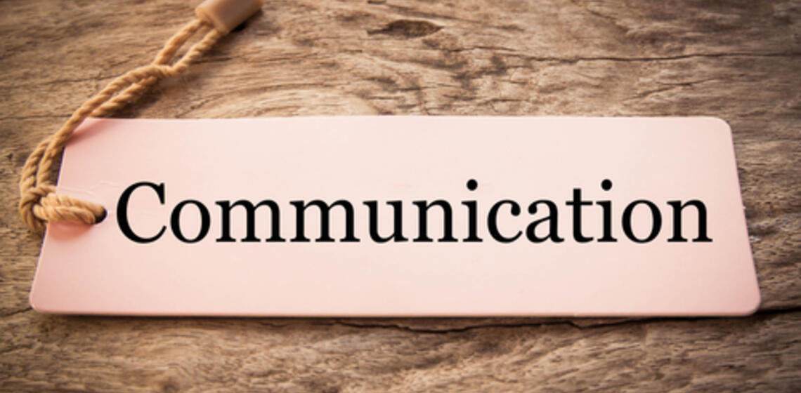Cream bookmark with a golden tassle that reads 'Communication'