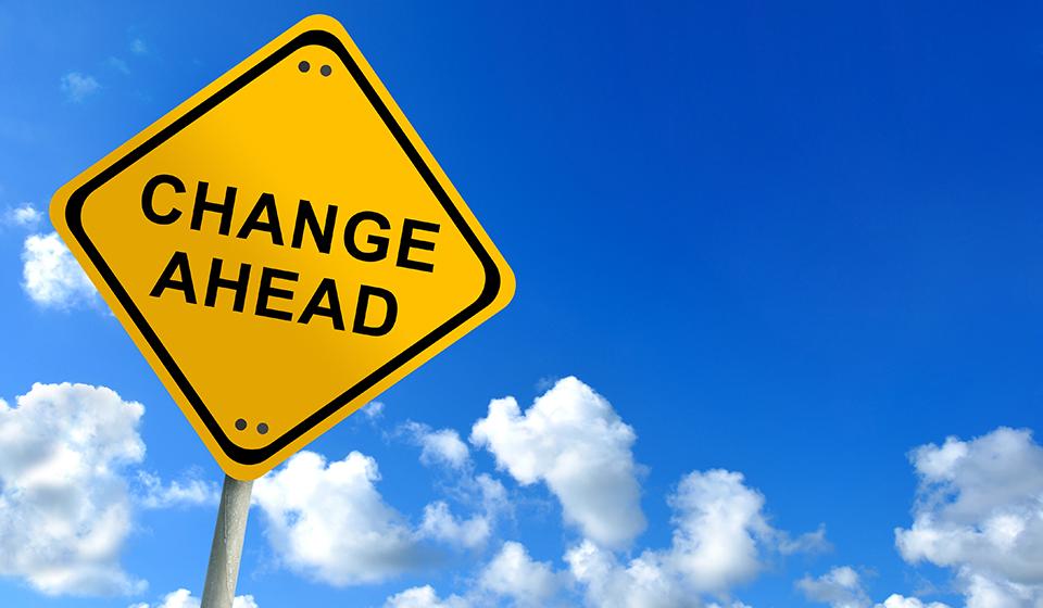 A yellow street sign reads "Change Ahead"