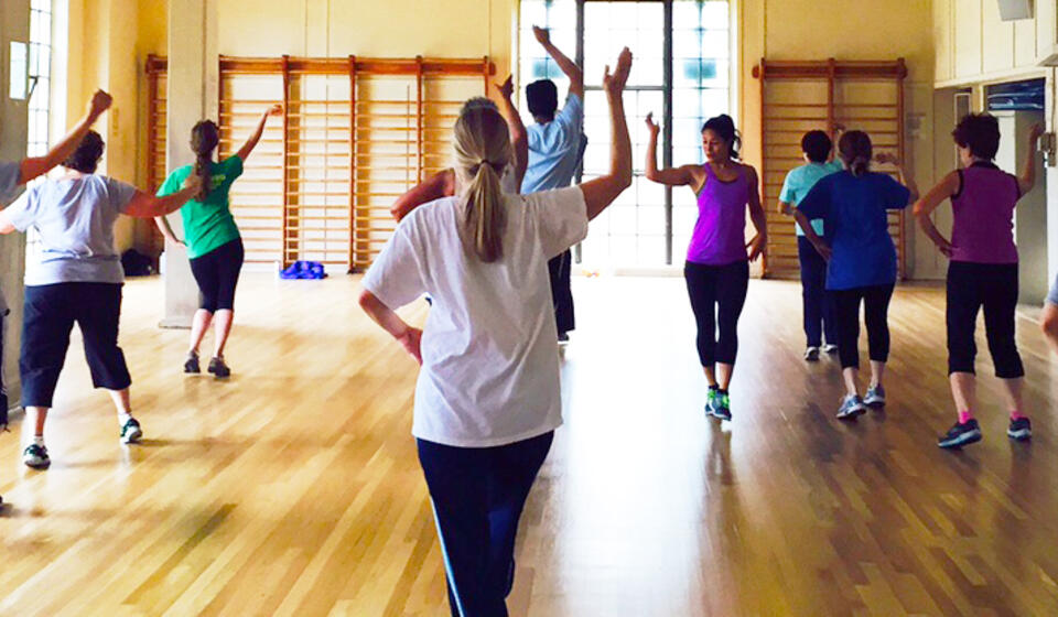 A group of people dancing in a gym