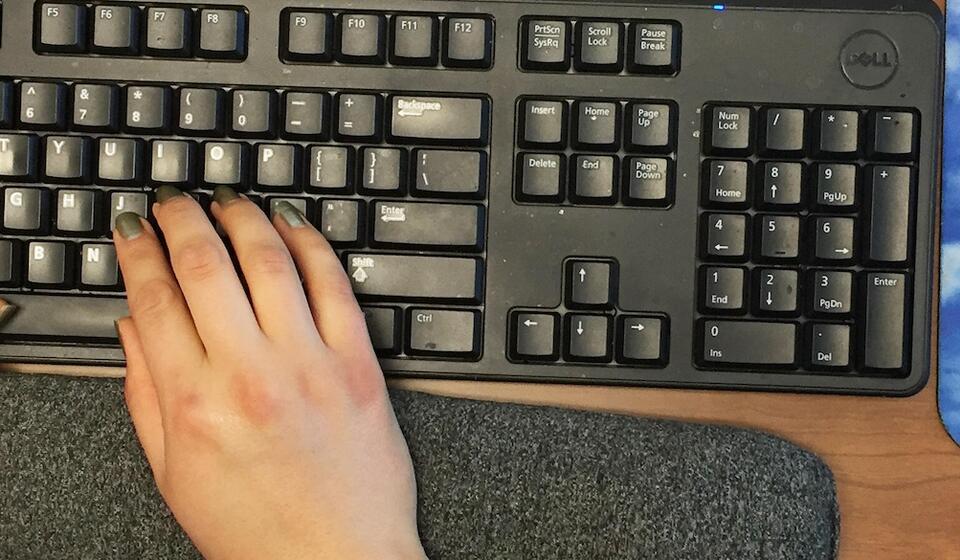 Hands typing on a keyboard