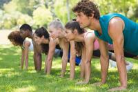 photo of young adults doing push ups