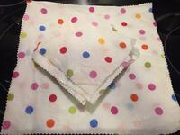 White fabric with colorful polka dots coated in melted beeswax