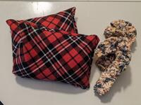 2 plaid print reusable hand warmers and 2 candy cane shaped birdseed ornaments