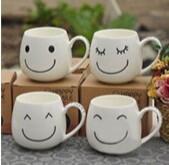 white ceramic mugs with a variety of black smiley faces drawn on them