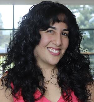 A headshot of a female communications specialist