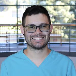 A headshot of a male medical assistant