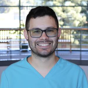 A headshot of a male medical assistant