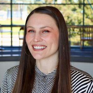 A professional headshot of a female health promotion staff