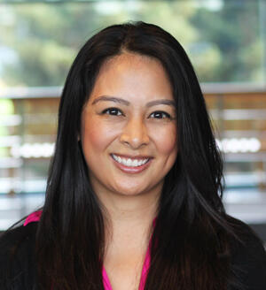 A headshot of a female Nurse Practitioner