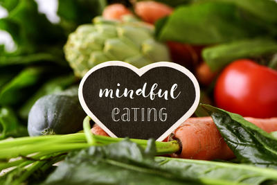 photo of vegetables with a sign that says mindful eating