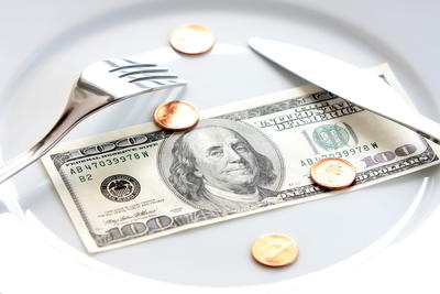 picture of plate with money on it and a fork and knife