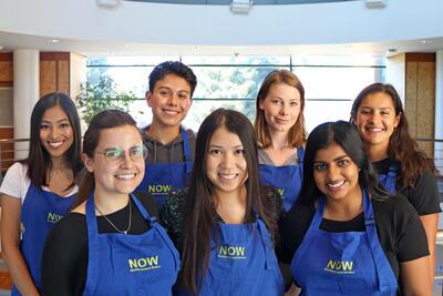 Nutrition Outreach Workers smiling for camera in their blue shirts.